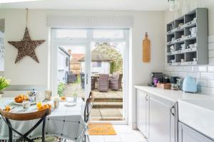 a kitchen with a table and a dining room at Danes House 4 in Aldeburgh