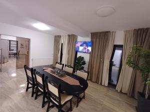 a dining room with a black table and chairs at Casa Ovidiu Rasnov in Râşnov
