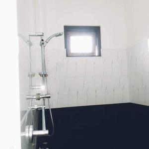 a shower in a bathroom with a window at Lagoonvilla hotel in Ambalangoda +129 photos