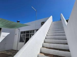 a stairway leading up to a white building at Blife Montya private rooms in Faro