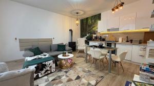 a living room with a couch and a kitchen at Manland Vendégház Lillafüred in Lillafüred