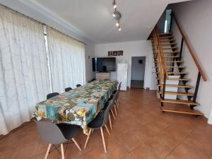 a dining room with a table and chairs and a staircase at Parti nyaraló in Balatonfüred