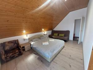 a bedroom with a bed and a couch in it at Parti nyaraló in Balatonfüred +10 photos