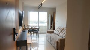 a living room with a couch and a dining table at 098house in São Luís