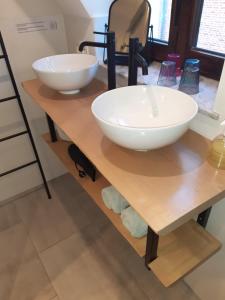 two white bowls on a wooden table in a bathroom at Het Maelslot (Mechelen) in Mechelen +41 photos