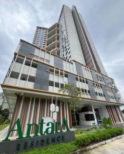 a tall building with a sign on the front of it at ResidenShals in Putrajaya
