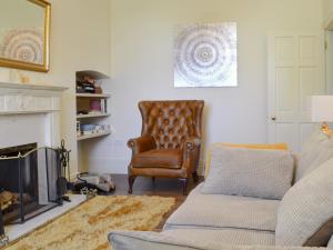 a living room with a couch and a chair at The Hind House in Cowlam
