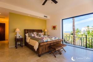 a bedroom with a bed and a balcony at Puerto Los Cabos Villa - Infinity Pool & Hot Tub in San José del Cabo