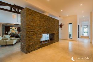 a large brick fireplace in a living room at Puerto Los Cabos Villa - Infinity Pool & Hot Tub in San José del Cabo +33 photos