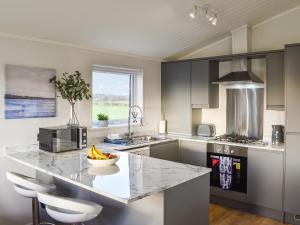 a kitchen with a counter with a bowl of bananas on it at The View - Uk36812 in Whalley +20 photos