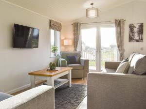 a living room with two couches and a tv at The View - Uk36812 in Whalley