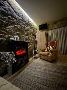 a living room with a couch and a fireplace at Casa do Albano in Viana do Castelo