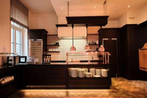 a kitchen with a counter with white plates on it at Hotel Alte Post in Konstanz