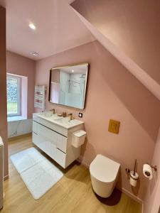 a bathroom with a sink and a toilet and a mirror at L'Echappée Belle in Laguiole +20 photos