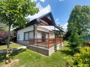 a home with a large deck and a house at Parti nyaraló in Balatonfüred