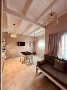 a living room with a table and a couch at Apart Los Laureles Dpto 2 in Villa Regina