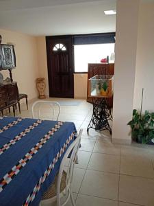 a bedroom with a bed and a table and a window at Moradia Lili in Ronqueira