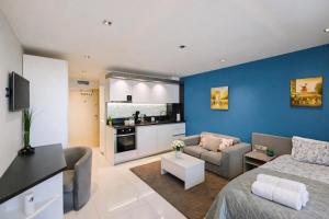 a living room with a couch and a kitchen at N9 Studentski Loft - Cozy Apt with Private Parking in Sofia