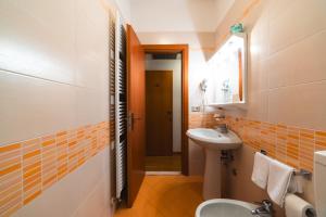 a bathroom with a sink and a toilet at Hotel Del Corso in Bibione +37 photos