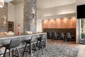 a bar in a lobby with black stools at Best Western Courtview Hotel in Springfield