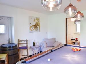 a living room with a pool table and a couch at Wesley Old Hall House in Bacup +24 photos