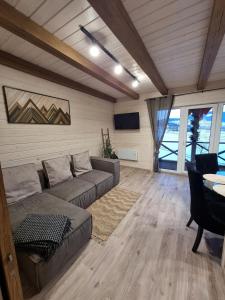 a living room with a couch and a table at Котедж Rest Hill in Vorokhta