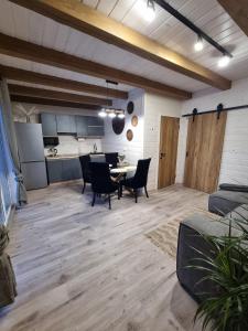 a large living room with a table and chairs at Котедж Rest Hill in Vorokhta