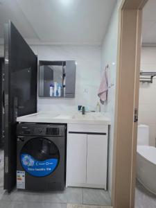 a washing machine in a bathroom with a sink at Purplehaze Place in Nairobi +11 photos