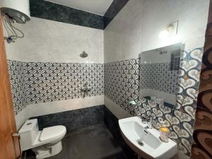a bathroom with a white toilet and a sink at Lila Niwas in Udaipur