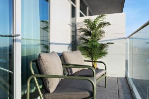 two chairs on a balcony with a plant at Willow, WorldHotels Crafted in Trelleborg