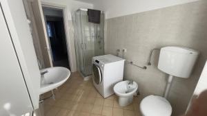 a bathroom with a toilet and a sink and a toilet istg at Fior di Luna in Stresa