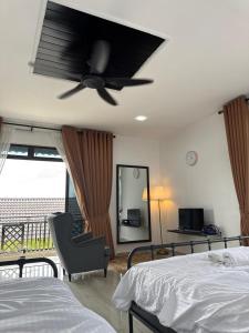 a bedroom with a ceiling fan and a bed at GG Studio in Kampong Sura +6 photos