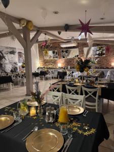 a dining room with tables and chairs with black and gold decorations at Domek Mustang in Bytom