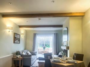 a living room with a table and a couch at Garth Cottage in Keswick