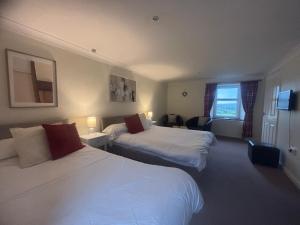 a hotel room with two beds and a window at Airds Farm Guest House in Castle Douglas +9 photos