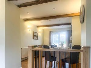 a kitchen and dining room with a table and chairs at Garth Cottage in Keswick
