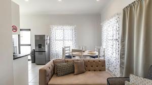 a living room with a couch and a table at Cozy Cove St Helena in West Point