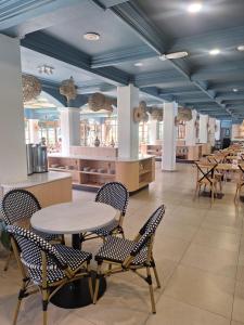 a restaurant with a table and chairs in a room at Hotel La Serena - Caja Los Andes in La Serena