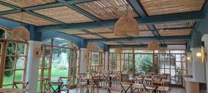 a dining room with tables and chairs and windows at Hotel La Serena - Caja Los Andes in La Serena +27 photos