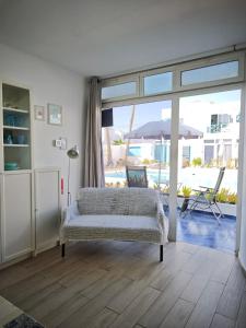 a bedroom with a bed and a patio with an umbrella at BLU in Puerto del Carmen
