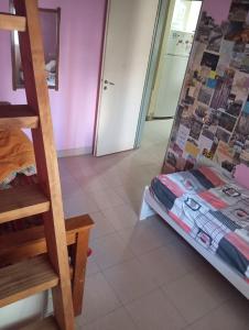 a room with a bunk bed next to a staircase at lo de Jor in Quequén