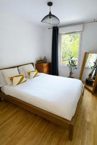a bedroom with a large white bed and a window at Passion et détente by UTA HOUSE in Saint-Denis +36 photos