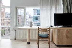 biurko z telewizorem i krzesłem przed oknem w obiekcie Nordic Light Hotel w Sztokholmie