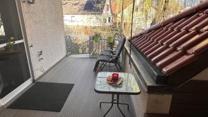 ein Balkon mit zwei Stühlen und einem Tisch auf einer Veranda in der Unterkunft Elsbach-Perle in Oberelsbach