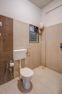 a bathroom with a toilet and a window at Urban Villa ,Baner in Pune