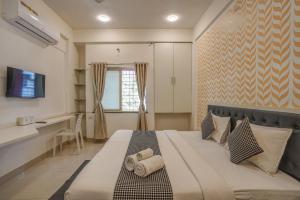 a bedroom with a large bed with towels on it at Urban Villa ,Baner in Pune