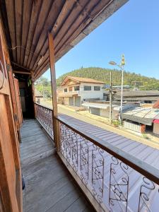 a balcony of a house with a view of a street at TEAK HOUSE In TOWN in Mae Hong Son