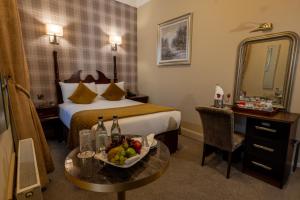 a hotel room with a bed and a table with a bowl of fruit at Atlantic Hotel in Lahinch +31 photos