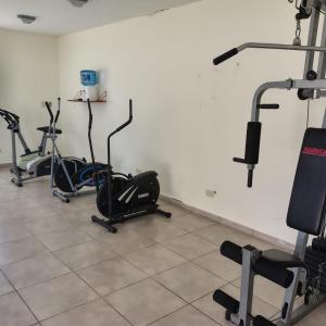 a gym with several exercise bikes in a room at Los corales torre norte in Santa Teresita
