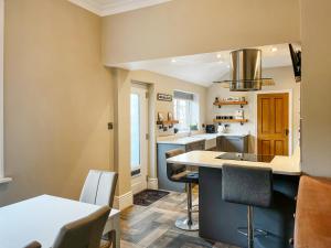 a kitchen with a sink and a counter top at Cracken Cottage - Uk48297 in Chinley +16 photos